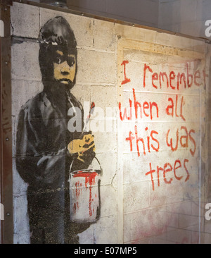 Detroit, Michigan - A painting by the graffiti artist Banksy on display at the nonprofit 555 Gallery. Stock Photo