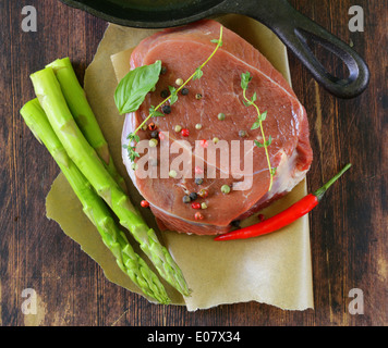 piece of raw meat beef steak with spices and herbs Stock Photo