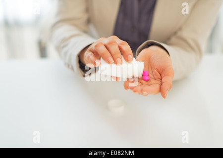 Business woman taking pills Stock Photo