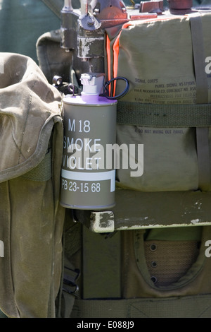 Violet Smoke grenade attached to an armed services rucksack Stock Photo