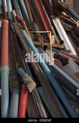 Reclaimed cast iron gutter and downpipe sections for recycling and reuse on repair and replacement work Stock Photo