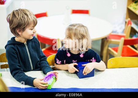 Kindergarten kids looking at each other in art class Stock Photo