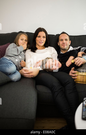 Family watching TV in living room Stock Photo