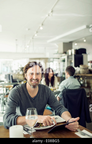 Portrait of mature businessman using digital tablet in restaurant Stock Photo