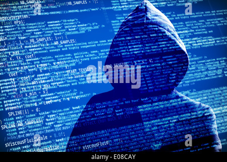 a hacker with a hood over a screen with software source code Stock Photo