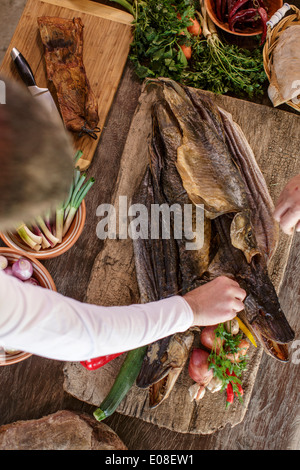 Person preparing pike on cutting board Stock Photo