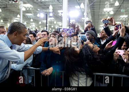 US President Barack Obama greets audience members after delivering remarks on raising the federal minimum wage at a Costco January 29, 2014 in Lanham, Maryland. Stock Photo