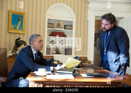 US President Barack Obama works on his State of the Union address with Director of Speechwriting Cody Keenan in the Oval Office of the White House January 21, 2014 in Washington, DC. Stock Photo