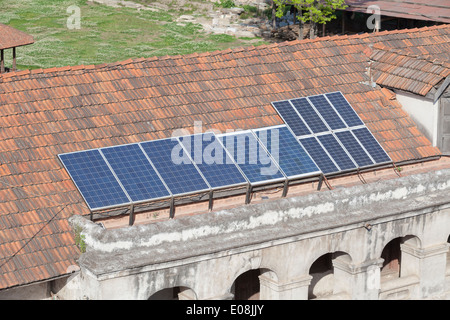 A solar panel is mounted on the roof of a house sale