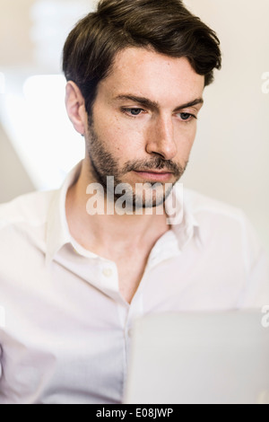 Businessman working on laptop in office Stock Photo