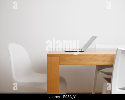 Laptop computer on a table in home office Stock Photo