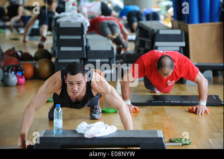 People doing push ups during Body Pump fitness class at the gym Stock Photo