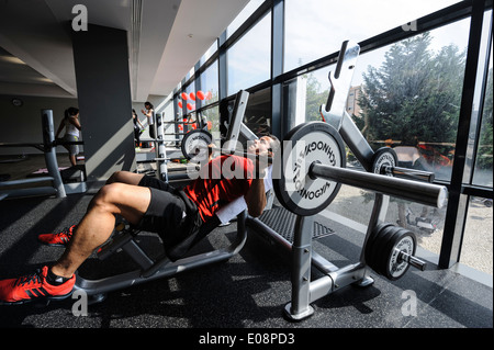 Man working out lifting weights at the gym Stock Photo