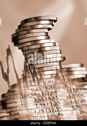 Stacked coins and currency rates Stock Photo