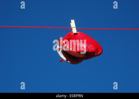 Illustration - A red wallet hangs from a clothes line in Germany, 14 June 2013. Fotoarchiv für Zeitgeschichte - ATTENTION! NO WIRE SERVICE – Stock Photo
