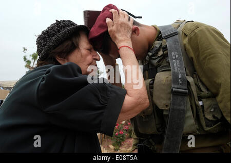 An elderly Jewish woman blessing an Israeli soldier of the 35th Brigade also known as the Paratroopers Brigade during 66th Independence Day celebrations in the Ammunition Hill which was a fortified Jordanian military post and the site of one of the fiercest battles of the 1967 War.in Jerusalem Israel Stock Photo