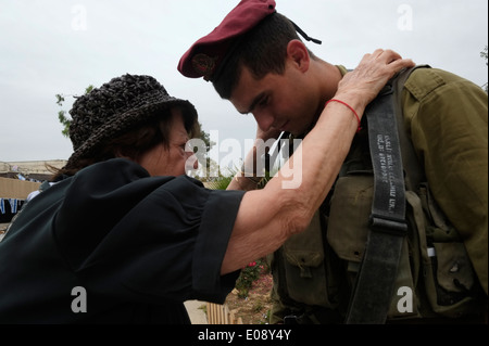 An elderly Jewish woman blessing an Israeli soldier of the 35th Brigade also known as the Paratroopers Brigade during 66th Independence Day celebrations in the Ammunition Hill which was a fortified Jordanian military post and the site of one of the fiercest battles of the 1967 War.in Jerusalem Israel Stock Photo