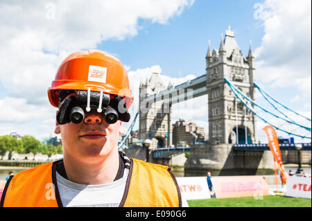 London, UK. 6th May, 2014.  Yo! Sushi, the iconic sushi restaurant asks the UK to support Japan as its second team in the upcoming World Cup tournament this summer.  The #TEAMTWO campaign is launched today with games of Japanese Binocular Soccer on London's Southbank. Binocular soccer is popular in Japan due to the optical eye pieces worn that makes everything look miles away. Credit:  Gordon Scammell/Alamy Live News Stock Photo