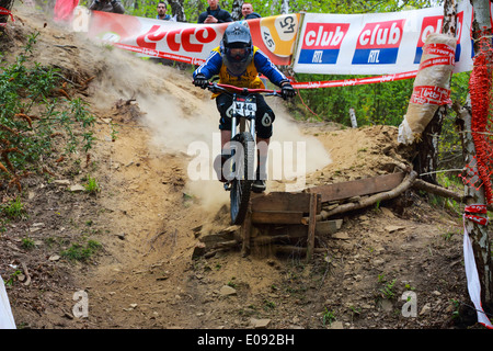 Rider jumping on dirt track. Down Hill mountain biking race in Chaudfontaine in Belgium, National championship. Stock Photo