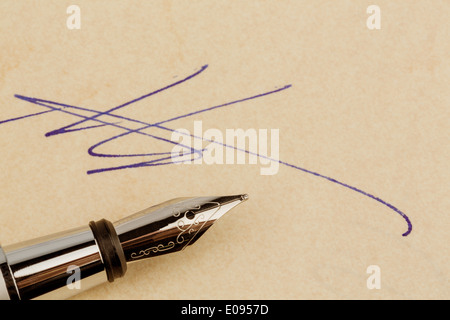 A contract or document is signed with a fountain pen personally., Ein Vertrag oder Schriftstueck wird mit einem Fuellhalter eige Stock Photo