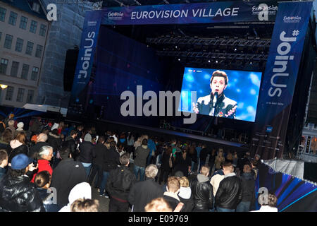 Copenhagen, Denmark. 6th May 2014. With some 170 music and cultural arrangement around Copenhagen the city has made this year European Song Contest a big party for the Copenhagener and the visiting tourists. Here a set-up with a giant screen at Nytorv at the main pedestrian street where Armenia's Aram Mp3 perform his song: “Not Alone” at the first semi final. “We are very proud of being able in presenting such a diverse cultural program,” says event manager Ulrich Ammundsen, Projektselskabet ESC 2014, in a press release. Credit:  OJPHOTOS/Alamy Live News Stock Photo