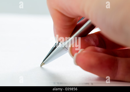 A hand with a fountain-pen with the Untrerschrift under a contract or testament., Eine Hand mit einer Fuellfeder bei der Untrers Stock Photo