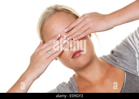 A young woman keeps closed to herself the eyes. Symbolic photo fue do not want to see and displacement as well as quarrel avoida Stock Photo
