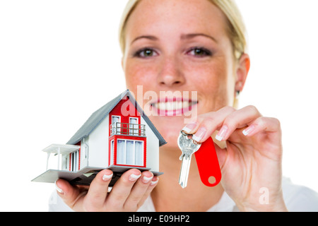 A broker fue real estate with a house and a key. Successful renting and house sales by estate agents., Ein Makler fue Immobilien Stock Photo
