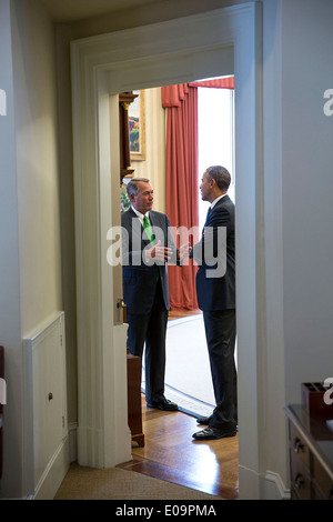 US President Barack Obama talks with House Speaker John Boehner at the end of their meeting in the Oval Office of the White House February 25, 2014 in Washington, DC. Stock Photo