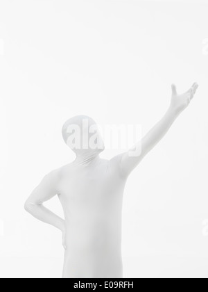 faceless man dressed in white with hand raised up Stock Photo