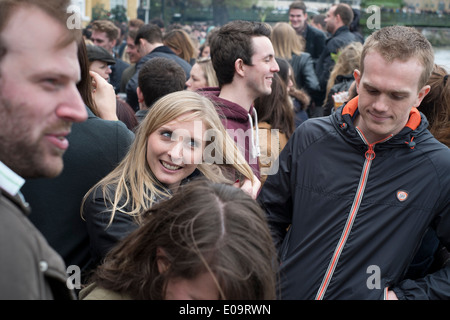 Spectators on the bank of the River Thames at Hammersmith during the annual Oxford and Cambridge Boat Race. Stock Photo