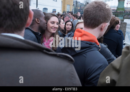 Spectators on the bank of the River Thames at Hammersmith during the annual Oxford and Cambridge Boat Race. Stock Photo