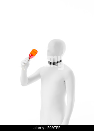 faceless man with bow tie holding colored champagne glass towards his mouth Stock Photo