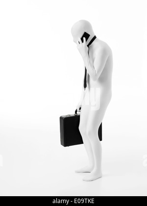 Hunched faceless businessman dressed in white, wearing tie, holding black briefcase talking on the phone Stock Photo