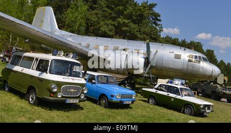 Finowurt, Germany. 25th Apr, 2014. A police van and a car (L and 2nd R) of the former Volkspolizei (people's police) and a blue Wartburg car model (2nd L) from the time of the GDR are on display next to an airplane of the type IL-14 during the 8th convention of East German transport vehicles in Finowurt, Germany, 25 April 2014. In 2013 more than 1000 participants took part in the convention which showcased East German-made transport vehicles ranging from bicycles to airplanes. Photo: Patrick Pleul/dpa/Alamy Live News Stock Photo