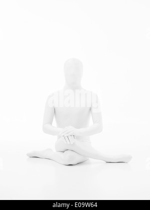 faceless man dressed in white yoga gomukhasana posture Stock Photo