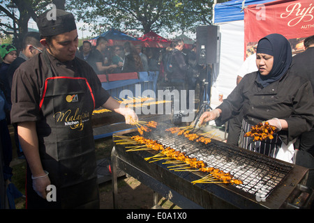 Food from the BBQ grill during a food festival on the Southbank. South Bank is a significant arts and entertainment district, it's riverside walkway busy with visitors and tourists. London, UK. Stock Photo