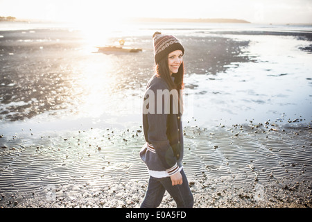 Young woman out strolling on the beach Stock Photo