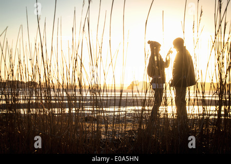 Silhouette of romantic young couple on the beach Stock Photo