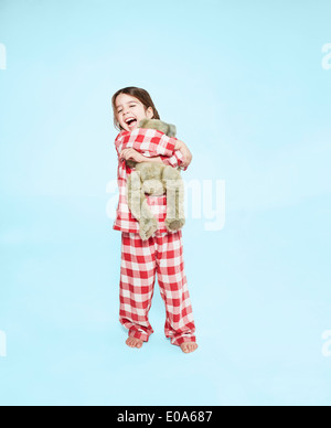 Girl hugging teddy bear Stock Photo
