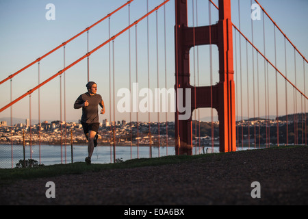 Young man out running near golden gate bridge Stock Photo