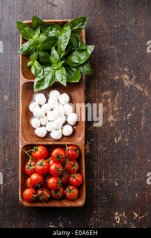 Green basil, white mozzarella, red tomatoes - Italian flag colors Stock Photo