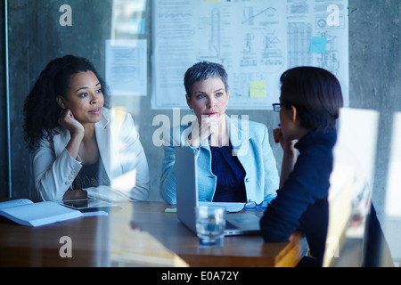 Three businesswomen discussing ideas in boardroom Stock Photo