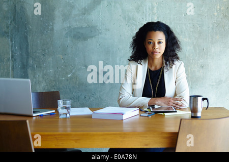 Portrait of young businesswoman at conference table Stock Photo