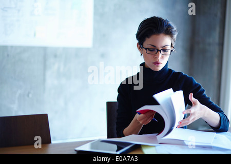 Young businesswomen searching through workbook in office Stock Photo