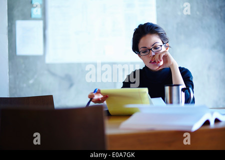 Young businesswomen studying paperwork in office Stock Photo