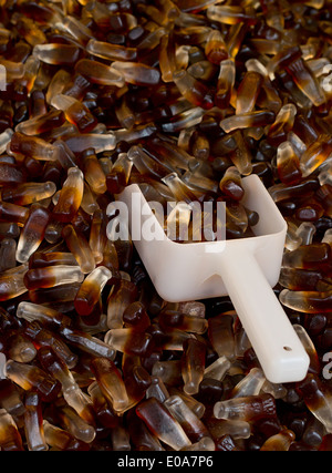 Chewy Cola Bottles a popular retro sweet also known as Gummy candy at a pick and mix self service market. Stock Photo