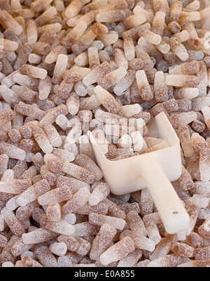 Fizzy Cola Bottles a popular retro sweet also known as Gummy candy at a pick and mix self service market. Stock Photo