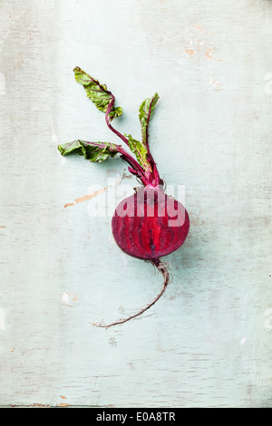 Ripe beet with leaves on textured background Stock Photo