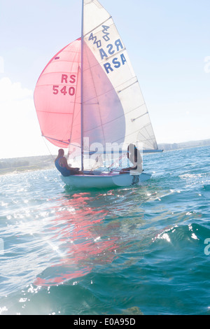Teenager sailing boat Stock Photo
